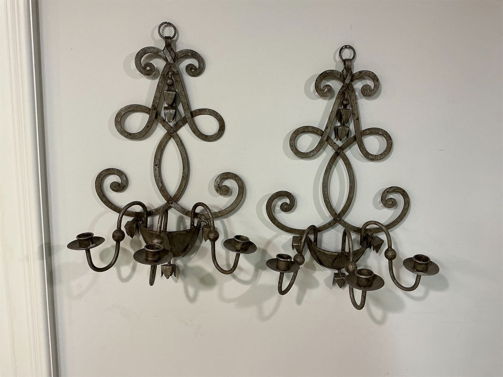 Vintage Rococo Wrought Iron Candle Wall Sconce: Exquisite pair of vintage Rococo-style wrought iron candle wall sconces combines elegance and charm, ideal for enhancing any living space. Each sconce features intricate scrollwork and a beautifully
