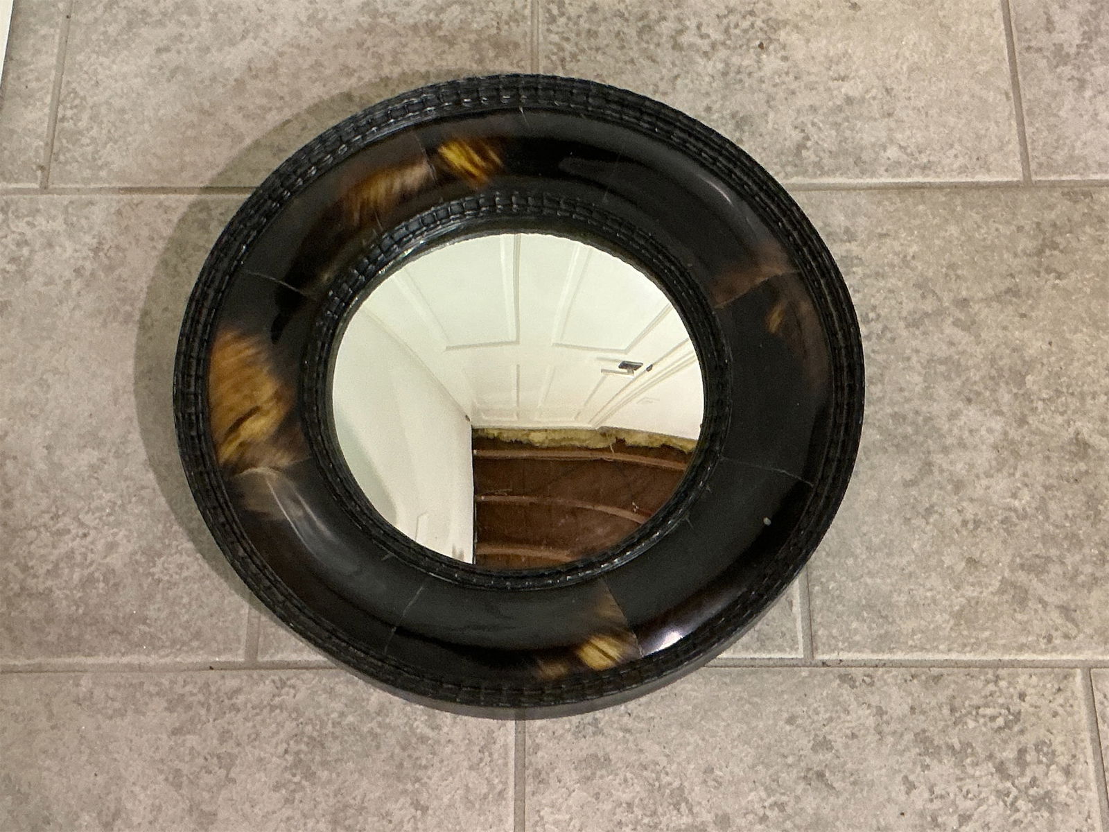 Tortoise Shell Hollywood Regency style Wall Mirror: Tortoise Shell Hollywood Regency style wall mirror features a stunning circular design that embodies the elegance of vintage decor. The mirror showcases a layered tortoise shell effect and is framed