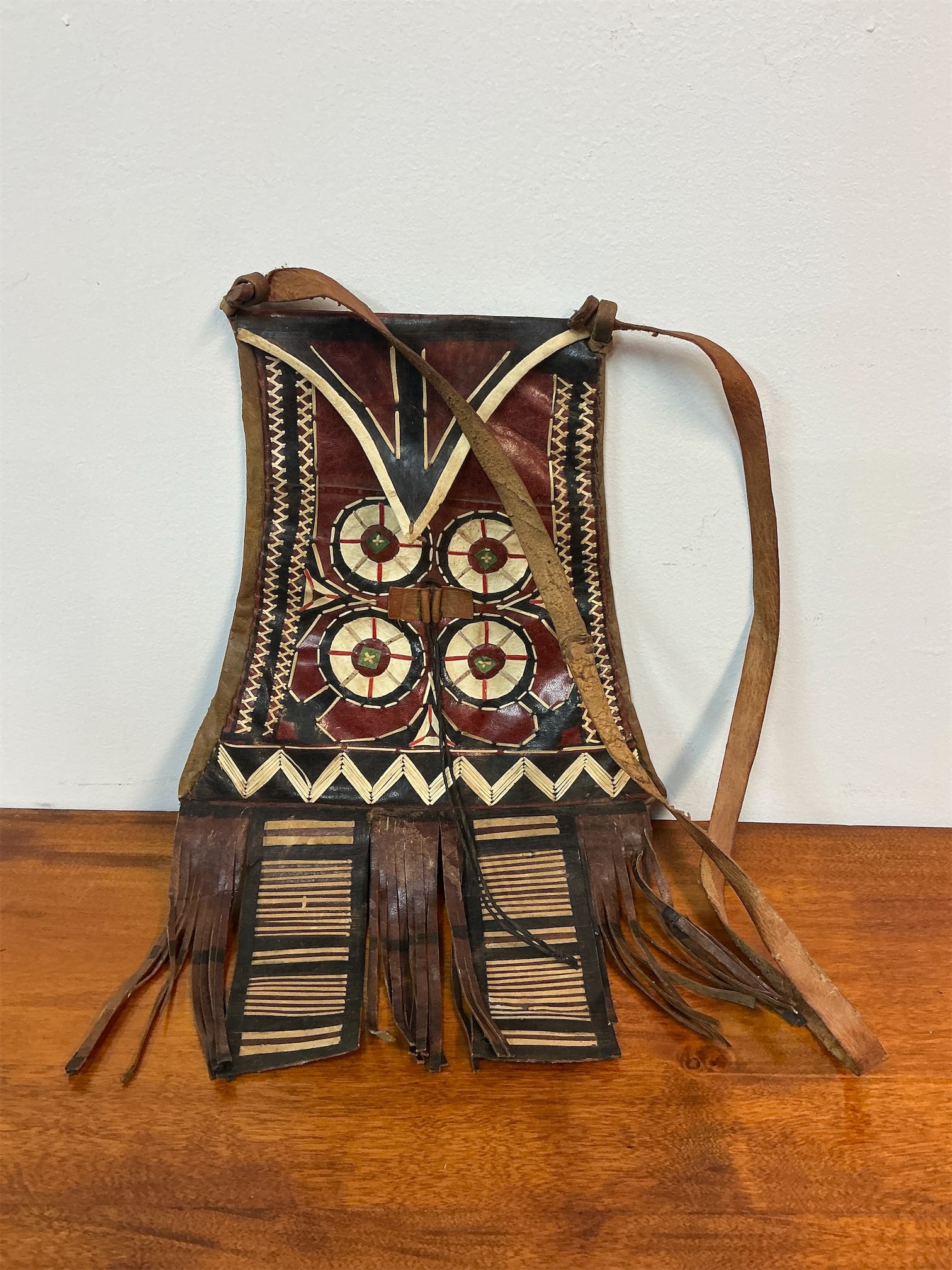 Vintage African Tuareg/Hausa Leather Shoulder Bag: Vintage African shoulder bag showcases exquisite craftsmanship and rich cultural heritage. Crafted by the Tuareg or Hausa people, the bag features striking geometric designs and vibrant colors,