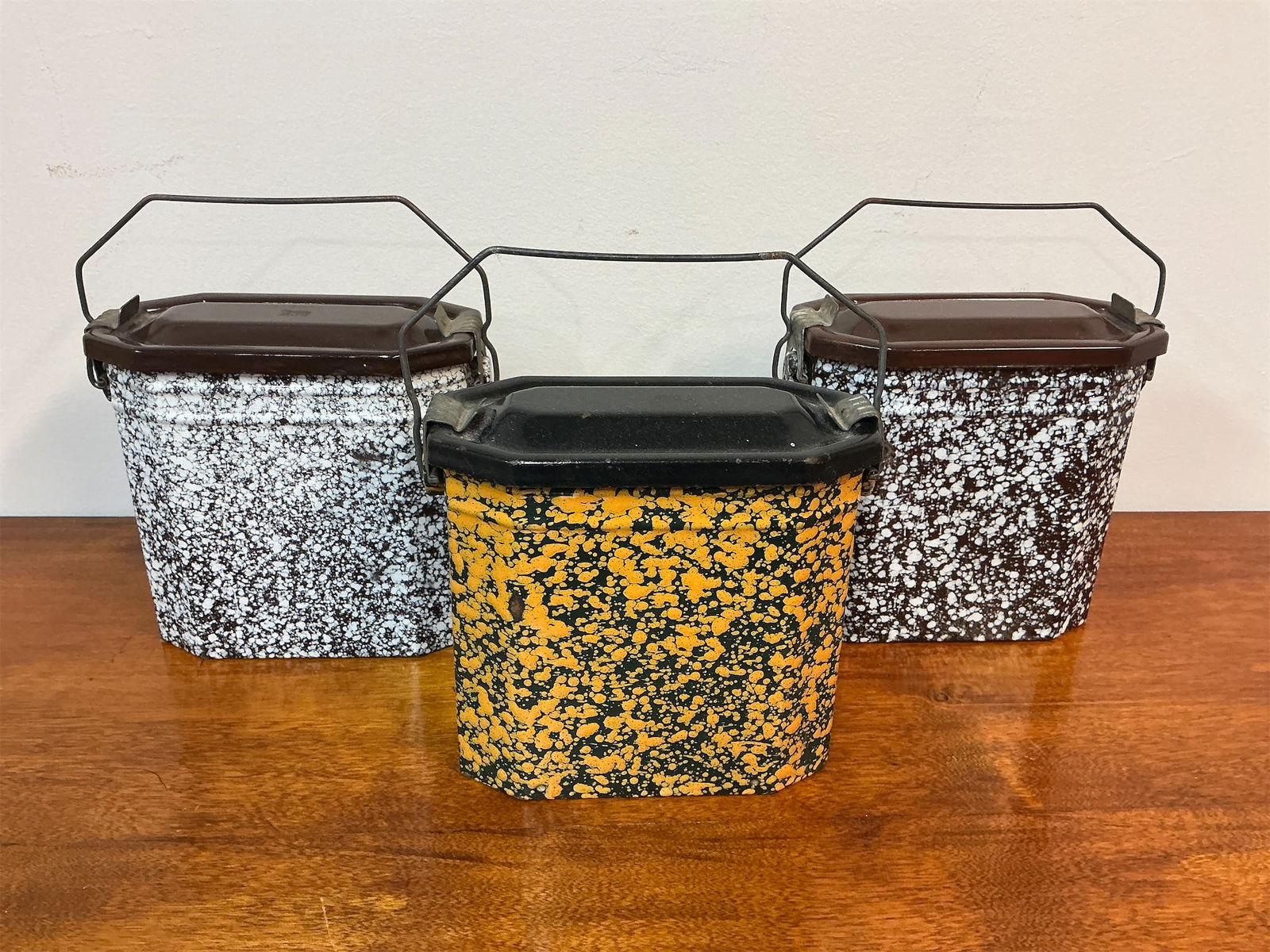 Vintage French Enameled Graniteware Lunch Boxes: Set of 3 Vintage French enameled graniteware lunch boxes showcases a charmingly rustic design with a speckled finish. Each box features a robust octagonal shape and is equipped with a sturdy metal