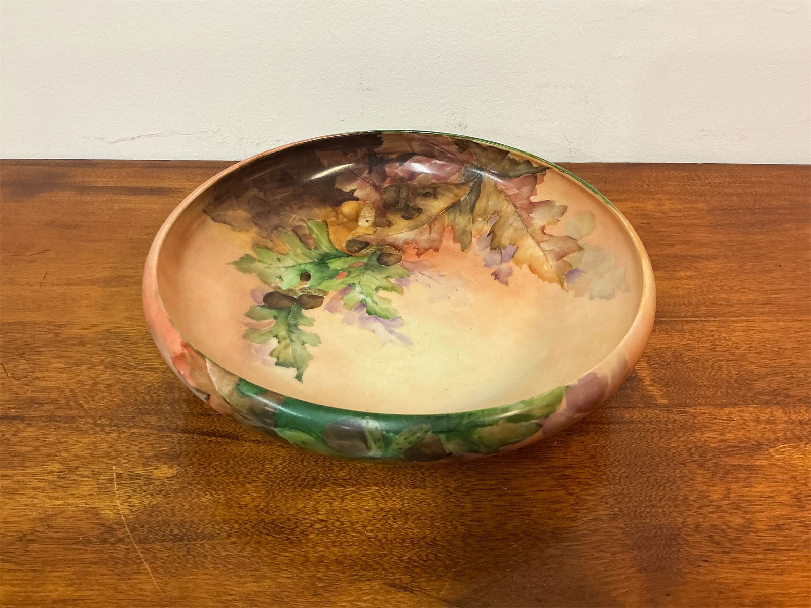 Antique Secession Austrian Porcelain Bowl: This Antique bowl showcases the artistry of Secessionist design, featuring a hand-painted motif of vibrant leaves and acorns. The soft, warm color palette transitions beautifully from earthy greens