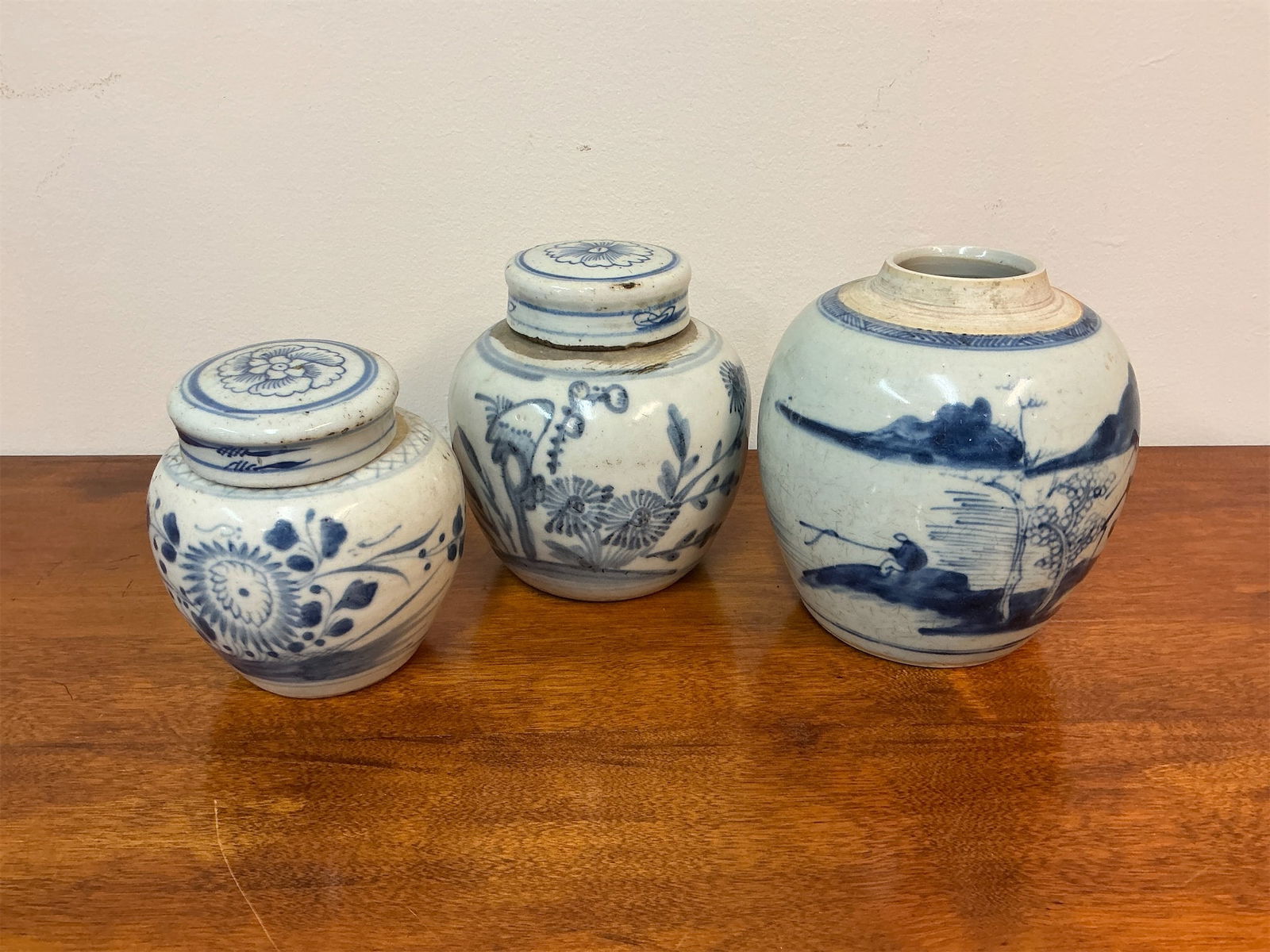Blue & White Porcelain Ginger Jars (Set of 3): Set of three blue and white porcelain ginger jars showcases exquisite craftsmanship and traditional design. Each jar features intricate blue floral and landscape motifs that reflect a classic