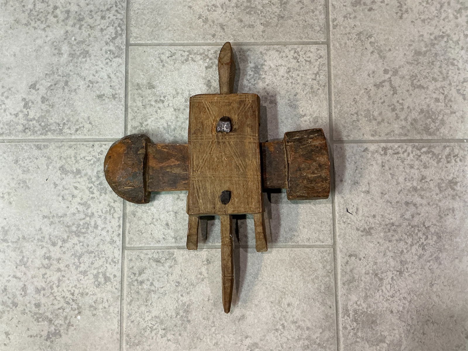 Hand-Carved Bamana or Dogon Door Lock from Mali: Hand-carved door lock originates from the Bamana or Dogon people of Mali, showcasing a remarkable blend of artistry and functionality. The lock features intricate designs etched into the wood,