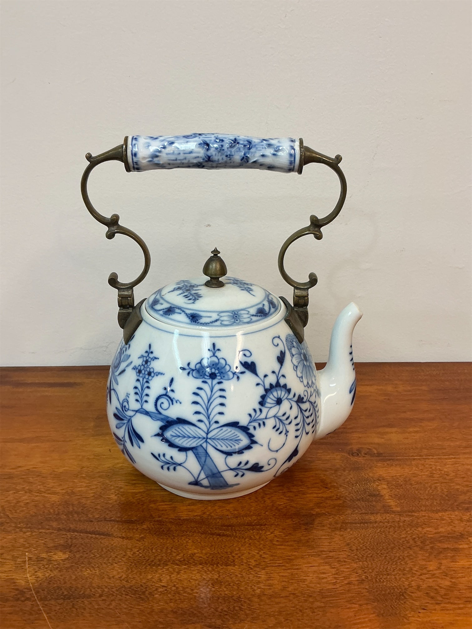 Antique Meissen Blue & White Porcelain Teapot: Meissen teapot features the iconic "Blue Onion" design, showcasing intricate blue floral and leaf motifs on a pristine white porcelain surface. The teapot is elegantly shaped, with a rounded body