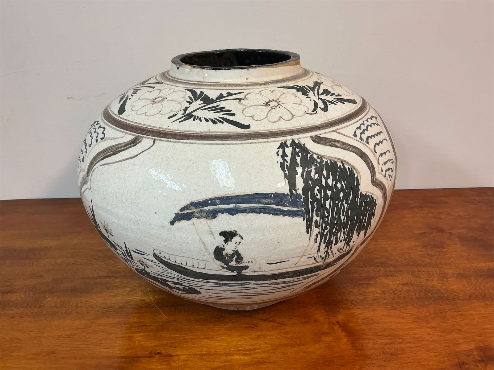 Vintage Chinese Cizhou Ware Style Jar: Vintage Chinese Cizhou ware style jar features a distinctive round shape and is adorned with intricate black and brown decorations. The jar showcases charming scenes, including figures engaged in