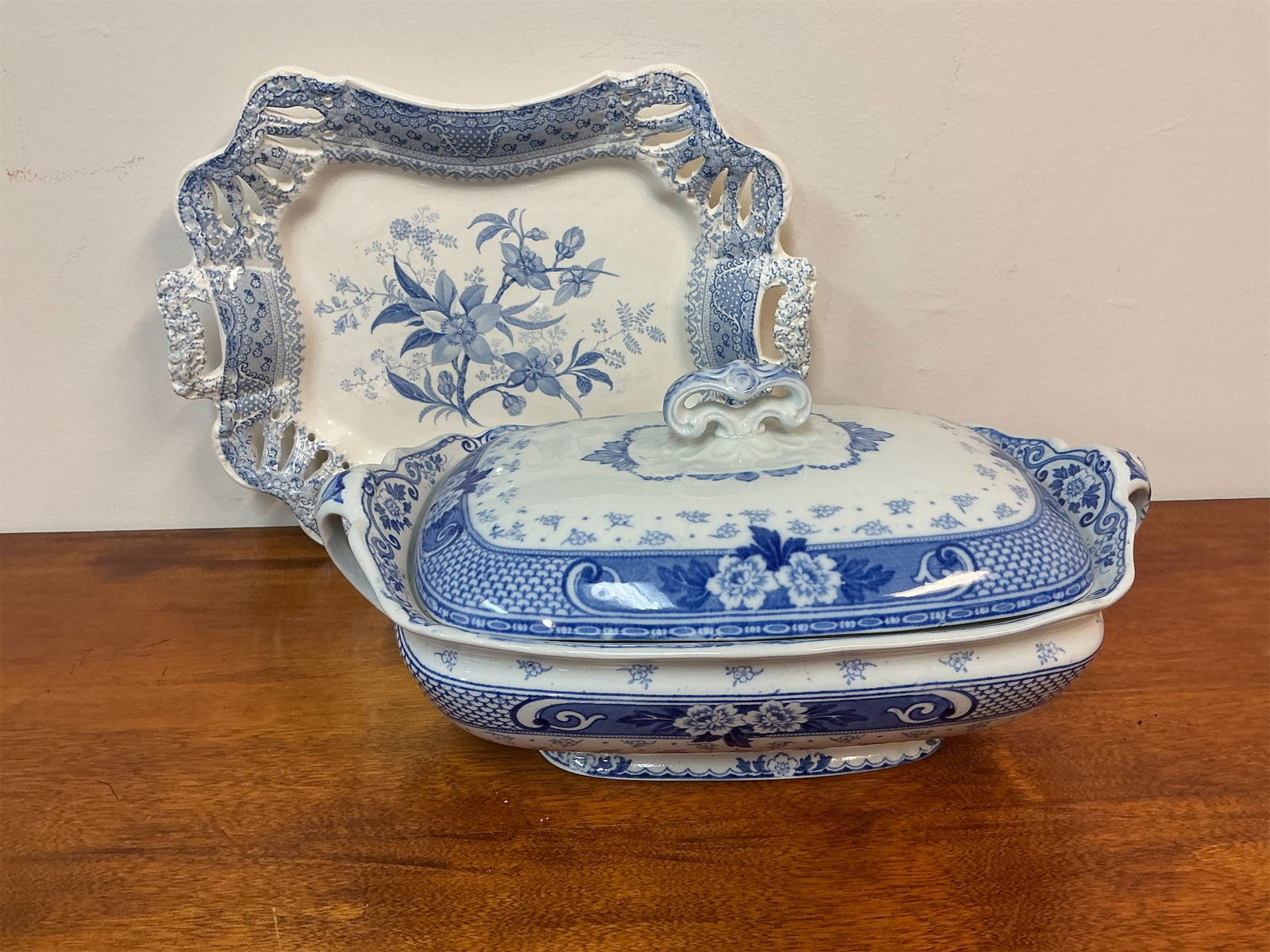 Ford & Sons Flow Blue Tureen with Lid and Serving Dish: Flow Blue tureen with lid, crafted by Ford & Sons, Burslem, England. Also included is an iconic Asiatic Plants pattern reticulated serving dish, designed with intricate blue transferware motifs that