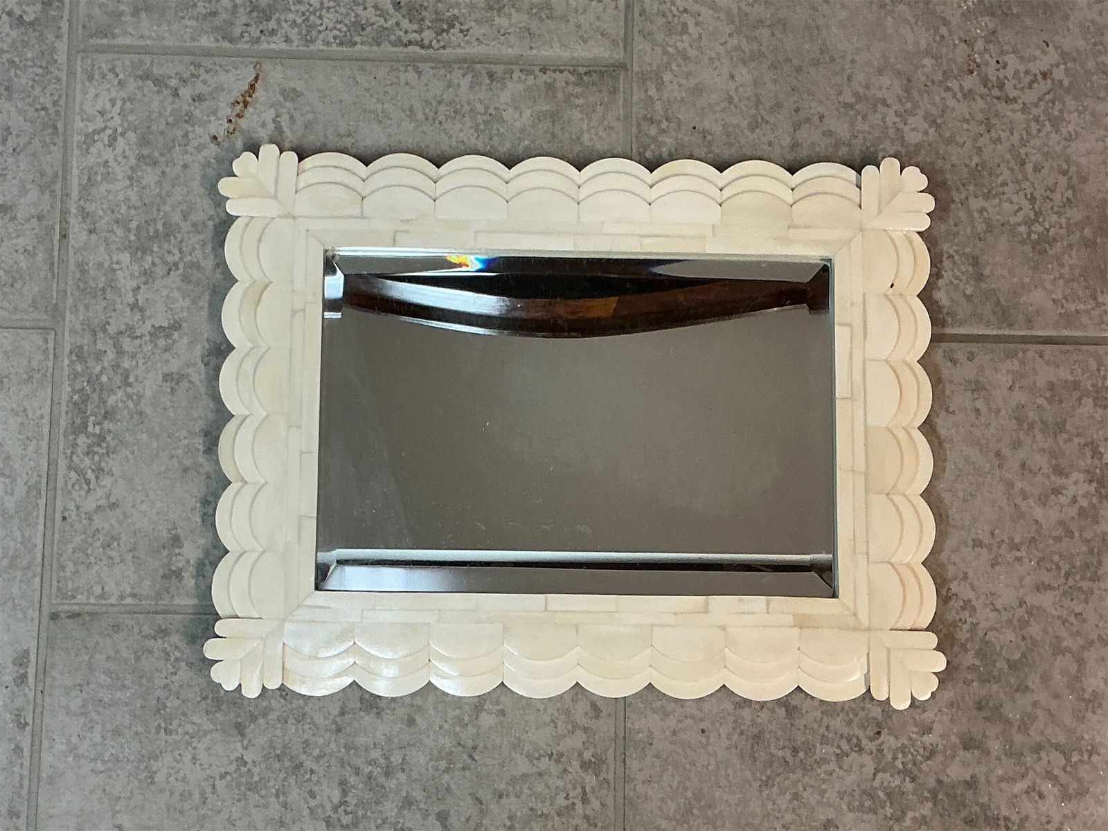 White Bone Scalloped Mirror: Elevate your decor with this charming White Bone Scalloped Mirror. The unique scalloped frame is intricately designed, showcasing a stunning pattern that adds a touch of elegance. The creamy white
