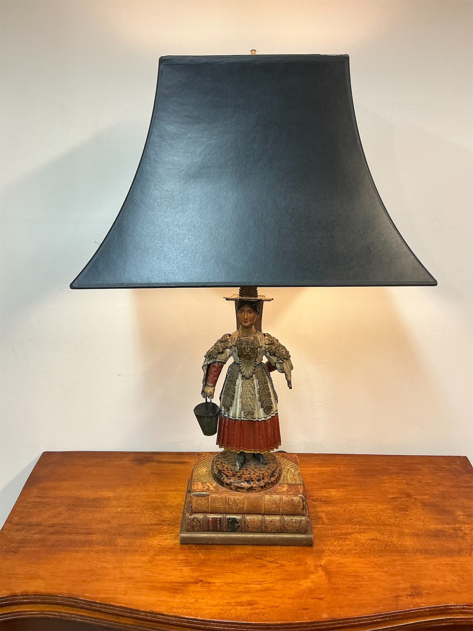 Regency Tole Figural Table Lamp: This Regency Tole Figural Table Lamp showcases exquisite craftsmanship and a charming design. The lamp features a beautifully detailed figural base depicting a woman dressed in period attire, holding