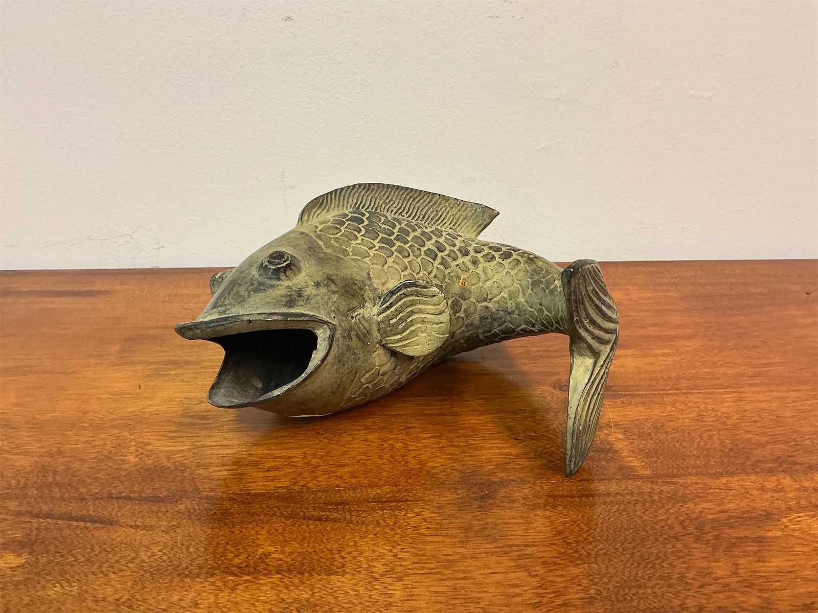 Vintage Bronze Koi Fish Sculpture: This vintage bronze koi fish sculpture showcases a beautifully detailed design, capturing the grace and charm of this iconic aquatic creature. The piece features intricate scales and a pronounced