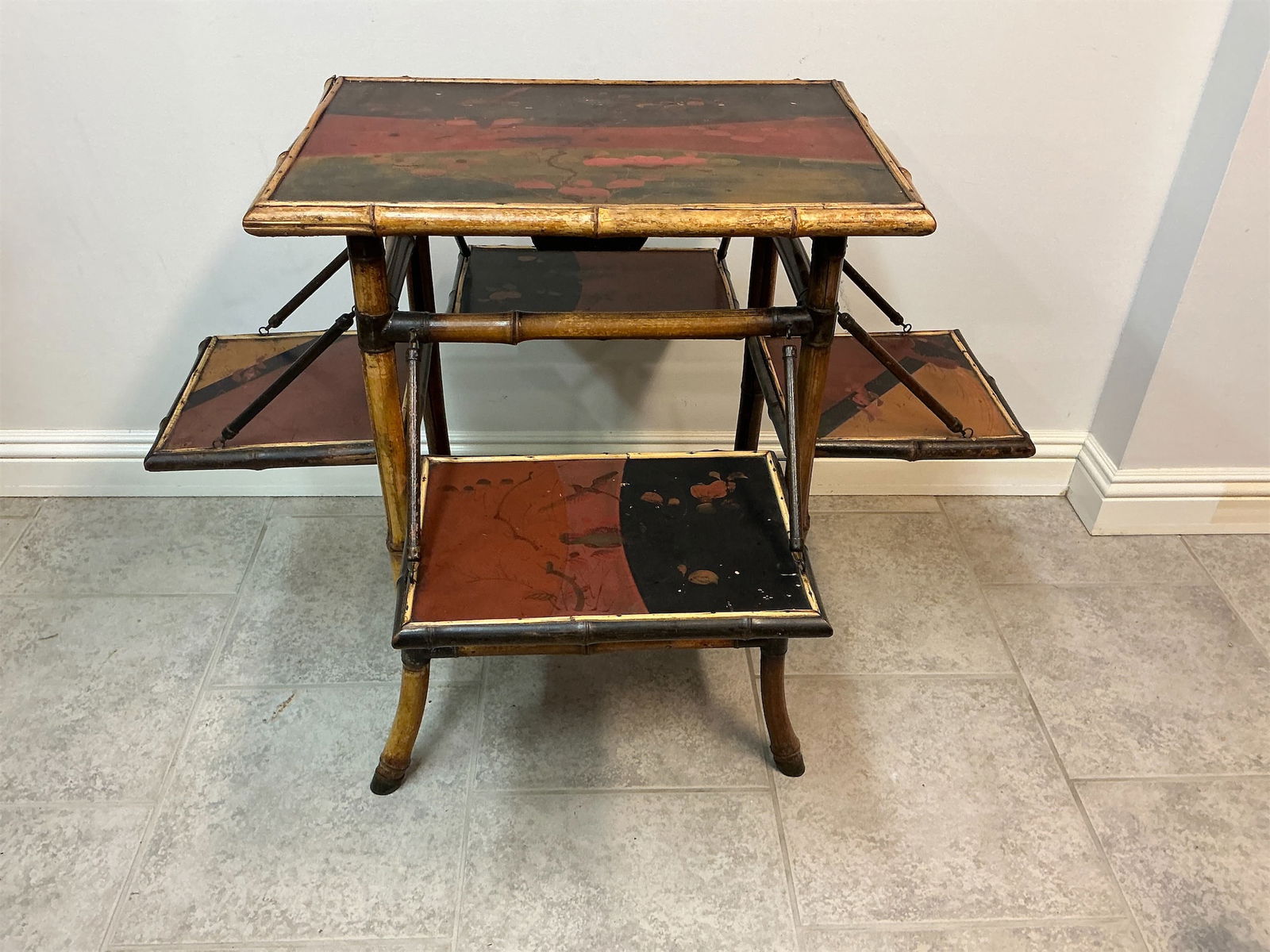 Antique English Bamboo Lacquer Table with 4 Trays: English bamboo Chinoiserie lacquer table showcases a unique blend of craftsmanship and artistry. Featuring a striking design, the table includes four fold-out trays, allowing for versatile use. The