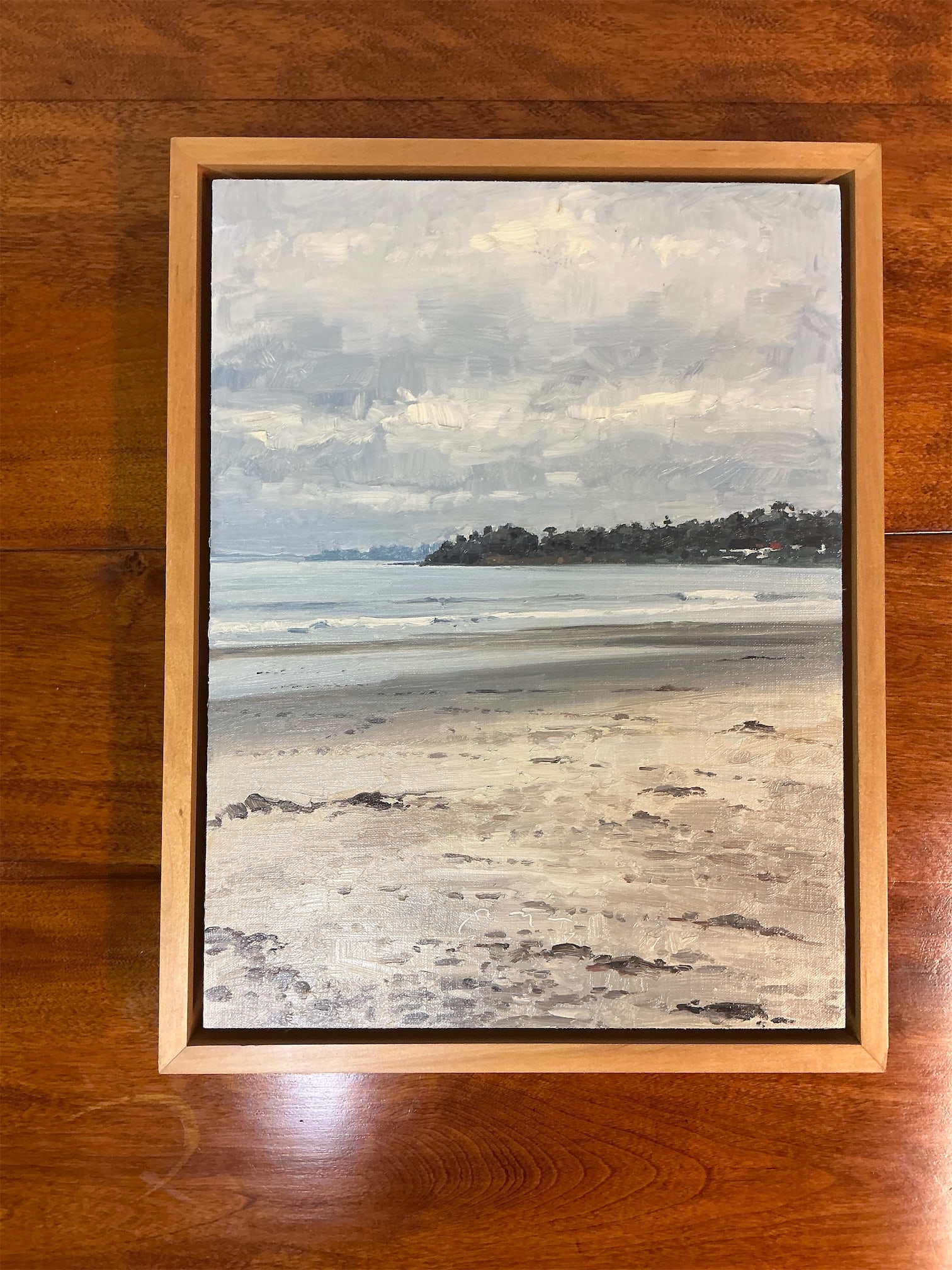 Framed oil on canvas Padaro Beach 5 by John Nava: This exquisite framed oil on canvas titled "Padaro Beach 5" by John Nava captures the serene beauty of a coastal landscape. The artwork showcases a tranquil seascape with gentle waves and a soft sky,