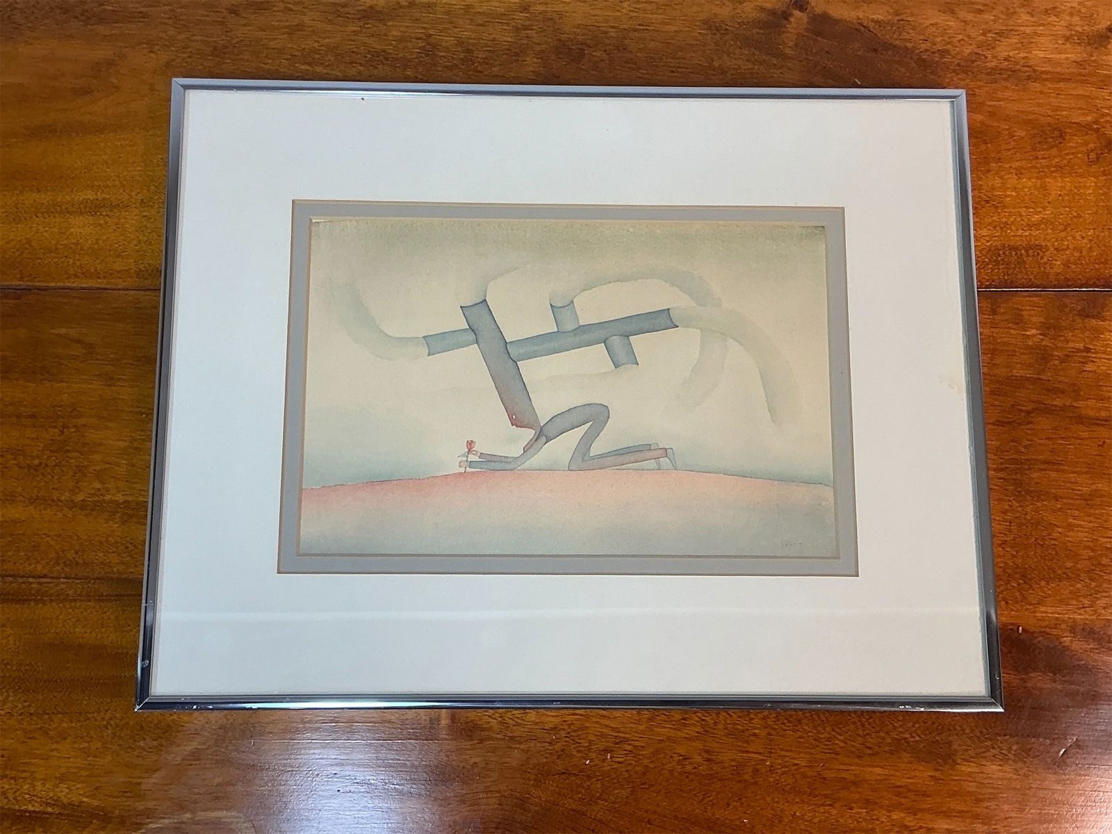 Signed modern watercolor La Mort d’un arbre by Jean-Michel Folon: Signed modern watercolor artwork by Belgian artist Jean-Michel Folon, features an intriguing composition marked by soft, flowing lines and a serene color palette. The piece, called “La Mort d’un