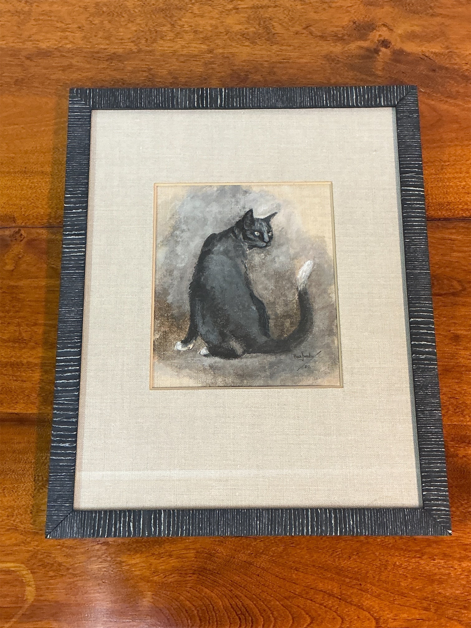 Signed oil pastel on linen of a cat: Signed oil pastel artwork features a beautiful depiction of a black cat in profile, seated elegantly against a soft, muted background. The artist's signature is visible in the lower right corner,