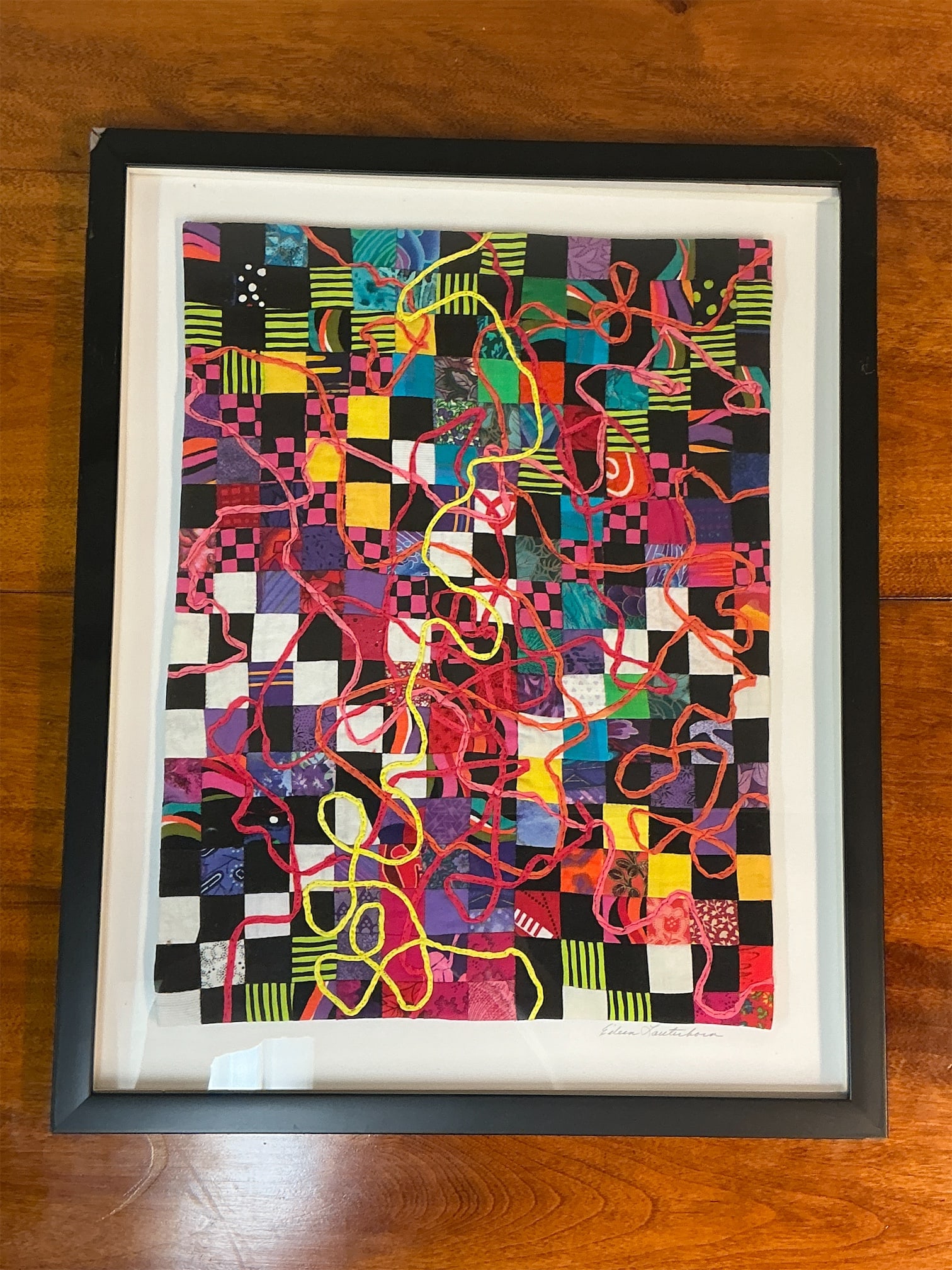 Framed Quilted Fiber Artwork Jazz Series: Jam Session II by Eileen Lauterhorn: Experience the vibrant energy of "Jazz Series: Jam Session II," a stunning framed quilted fiber artwork by Eileen Lauterhorn. This piece showcases a colorful arrangement of squares in a dynamic