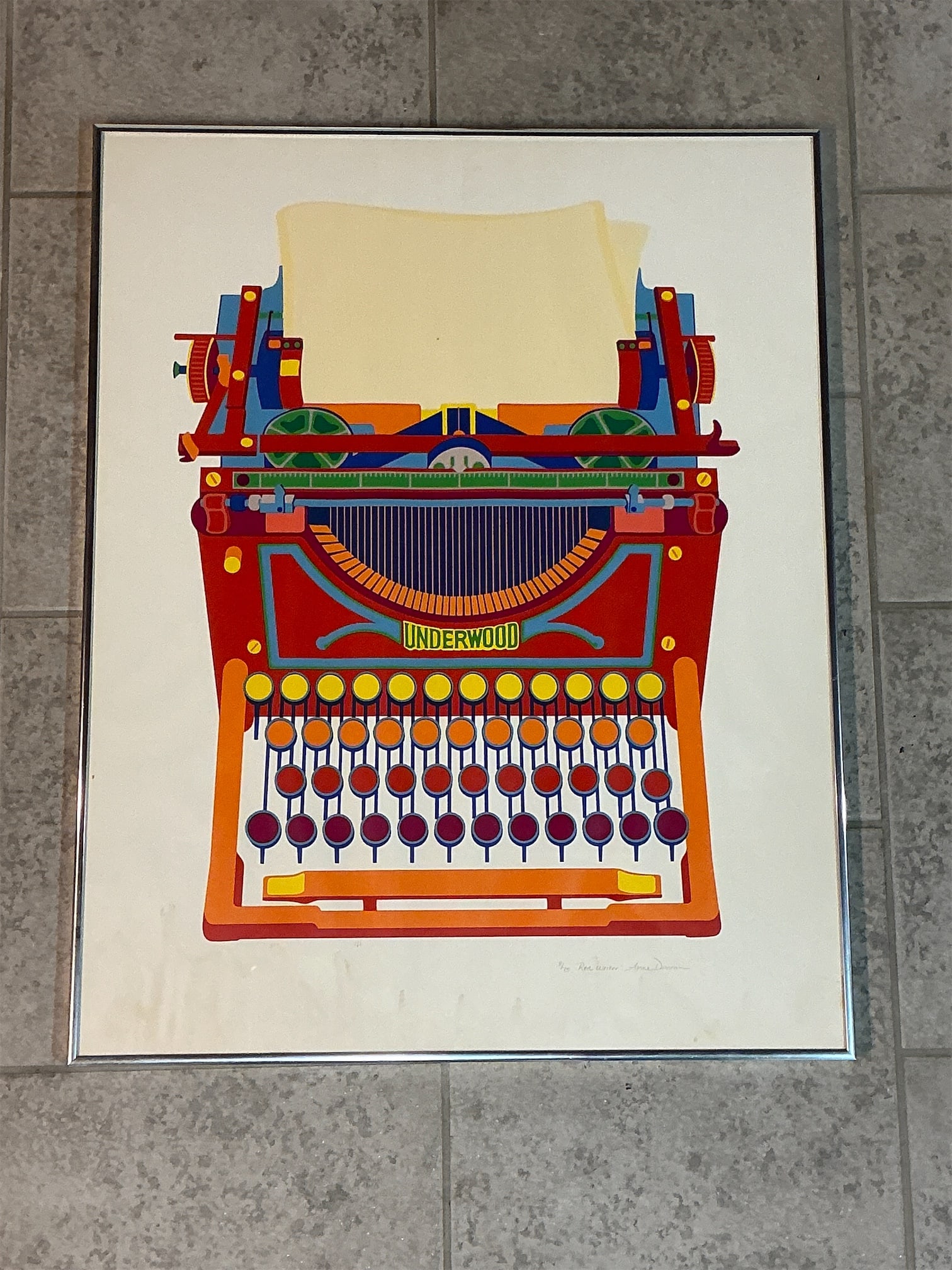Framed Silk Screen Red Writer by Anne Duncan: This striking silk screen titled "Red Writer" by Anne Duncan features a vibrant depiction of a classic Underwood typewriter, bursting with bold colors and artistic flair. The artwork showcases intrica