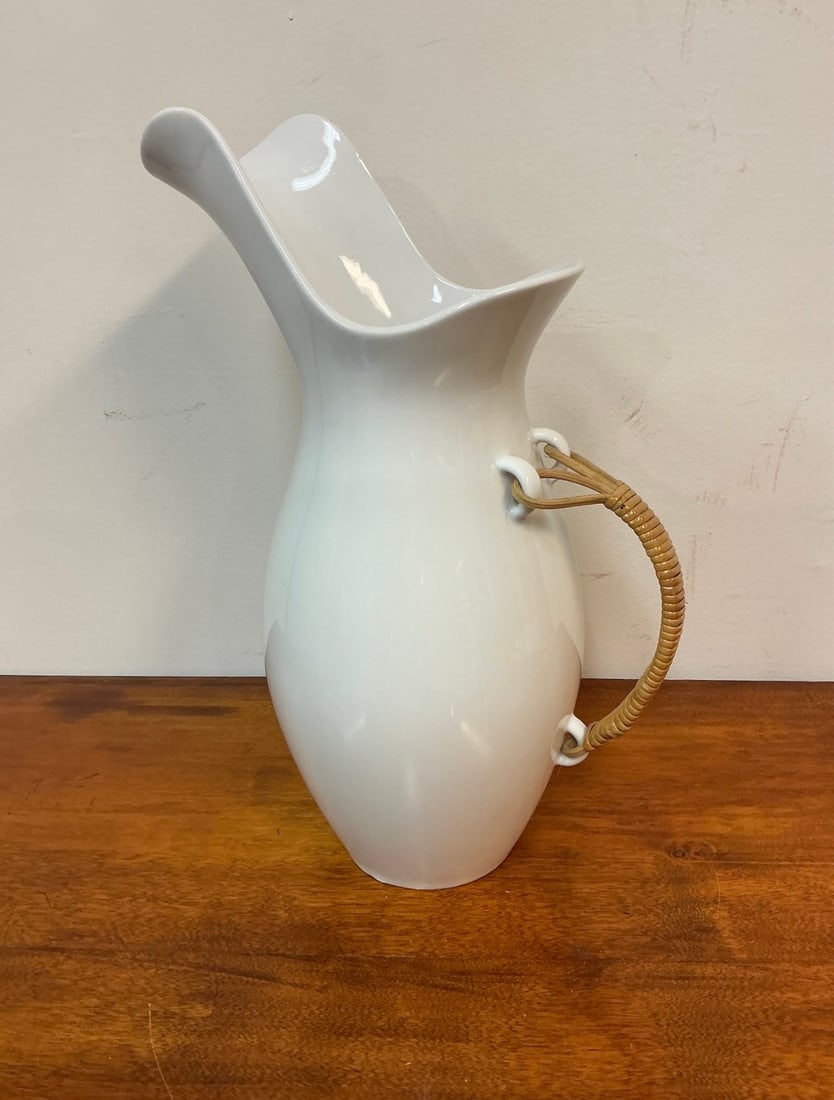 Vintage White Ceramic Pitcher with Bamboo Handle by Kenji Fujita: This vintage white ceramic pitcher, designed by Kenji Fujita, showcases an elegant, minimalist aesthetic. The pitcher features a gracefully curved body and a distinctive flared spout, enhancing its