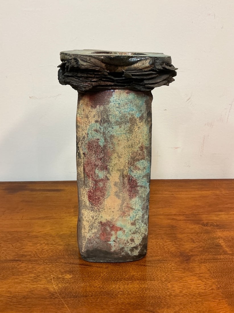 Signed Studio Art Pottery Ceramic Candle Holder: This unique studio art pottery ceramic candle holder showcases a stunning blend of colors and textures, perfect for adding an artistic touch to any space. The candle holder features an intriguing squa
