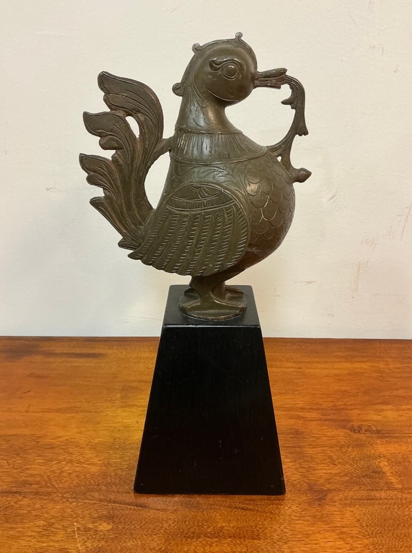 Brass Indian Hamsa Bird Figure: This exquisite brass Hamsa bird figure showcases intricate craftsmanship and cultural significance. The bird is elegantly styled, featuring detailed feather patterns and a graceful tail. Its charming