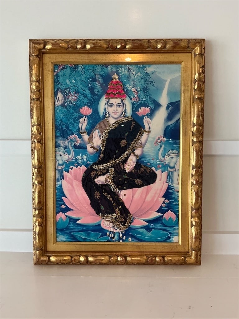 Framed Radha Krishna Tanjore style painting: This exquisite framed Radha Krishna Tanjore style painting features intricate detailing and vibrant colors. The artwork captures Radha adorned in an elegant black saree embellished with gold accents,
