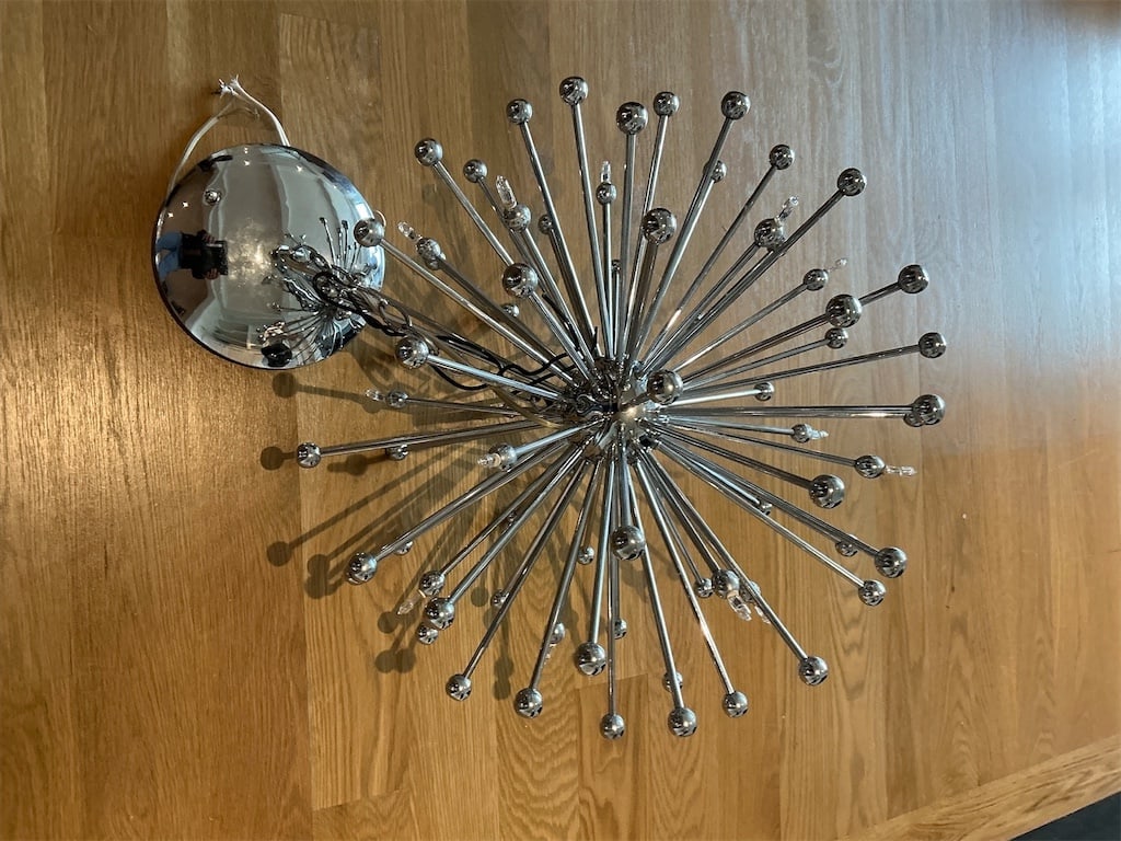 1970's Space age Sputnik chandelier: This stunning 1970's Space Age Sputnik chandelier embodies the iconic retro design of the era. Featuring a dynamic arrangement of chrome arms extending outward, each topped with spherical detailing, t