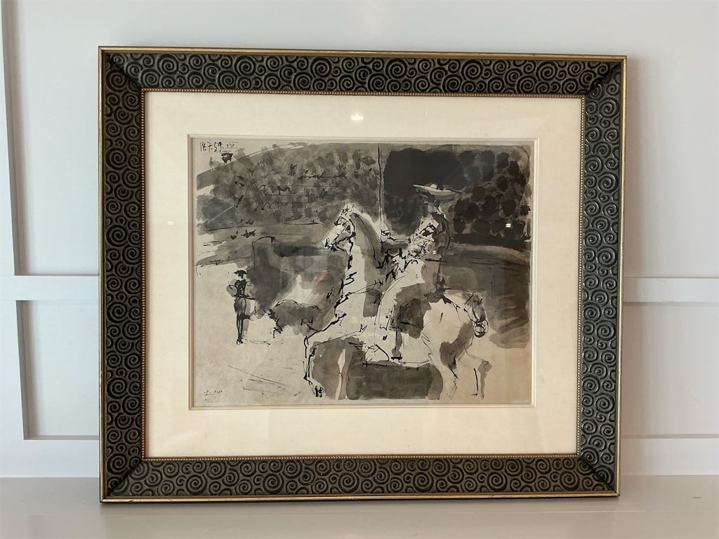 Framed and signed print of the lithograph D'AP S Pablo Picasso: This exquisite framed print features a lithograph by the renowned artist Pablo Picasso, titled "D'AP S." The artwork showcases a striking monochromatic palette, capturing dynamic figures of horse ride
