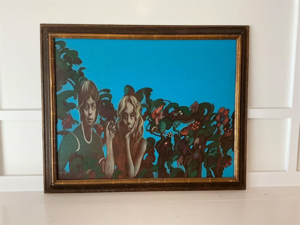 Framed Original oil on canvas By: Gilbert L Stone: This original oil on canvas artwork by Gilbert L. Stone features two figures amidst vibrant floral and foliage elements, set against a striking blue background. The painting captures a moment of