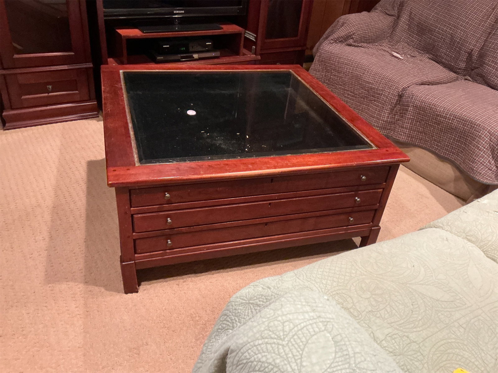 Coffee Table: This elegant coffee table features a stunning wood finish with a rich, warm tone that enhances any living space. The table boasts a square design with a glass top, allowing for a modern touch while sh