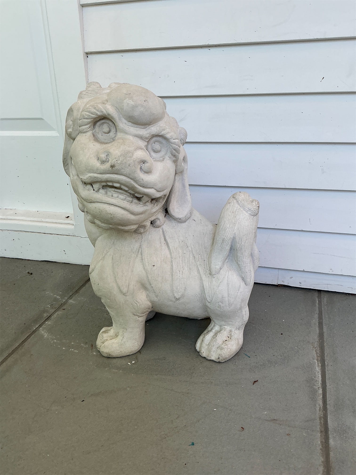 Stone Foo Dog: This stone Foo Dog is a charming decorative piece, ideal for enhancing your garden or home entrance. Its detailed craftsmanship showcases a classic design, featuring a fierce yet endearing