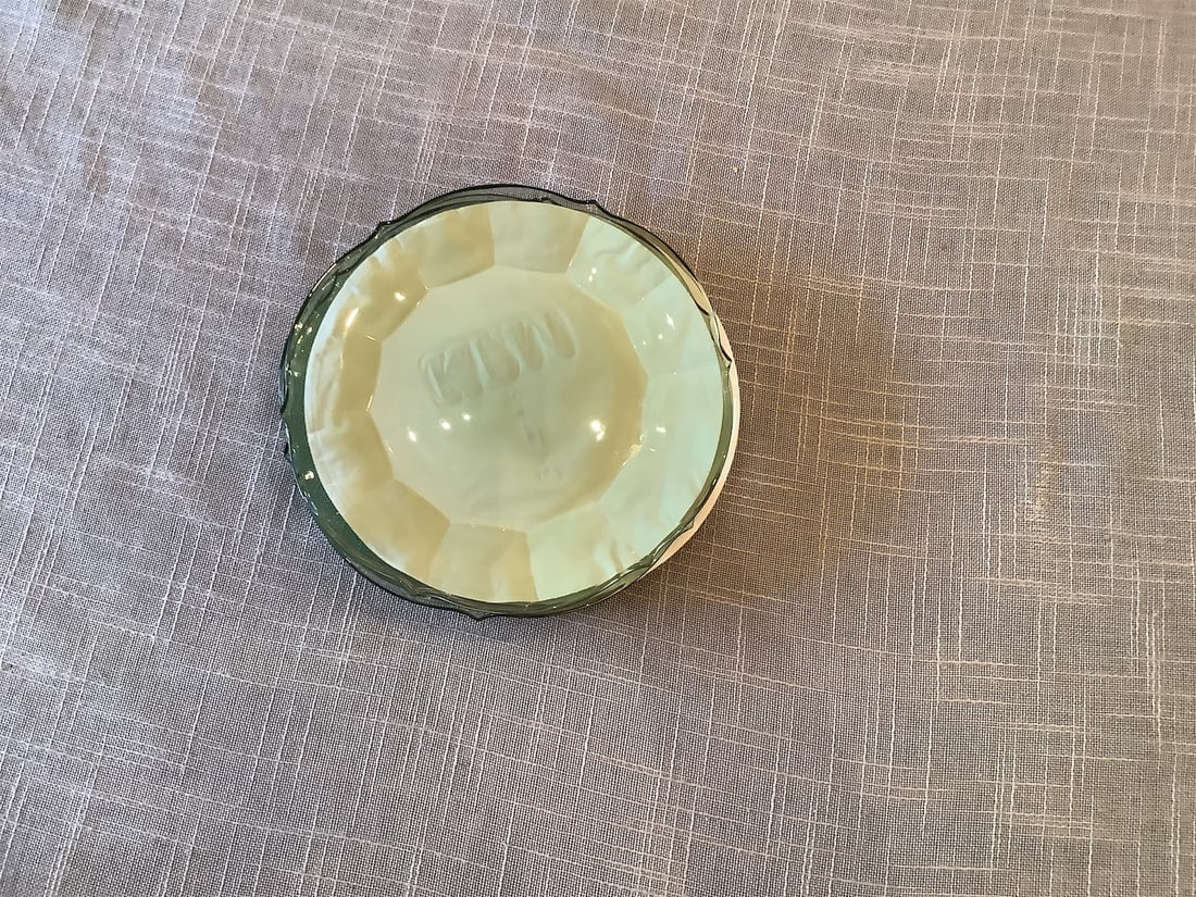 Villeroy & Boch Plates: Set of elegant Villeroy & Boch plates featuring a unique design that blends classic sophistication with modern aesthetics. The plates showcase a beautiful pale green color with a finely scalloped
