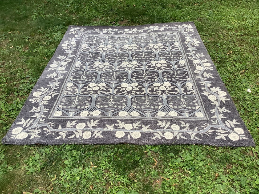 Handmade in India Tahari rug: This exquisite handmade Tahari rug from India features a stunning floral design, intricately crafted to enhance any space. The rug showcases an elegant color palette of deep grays and soft whites,