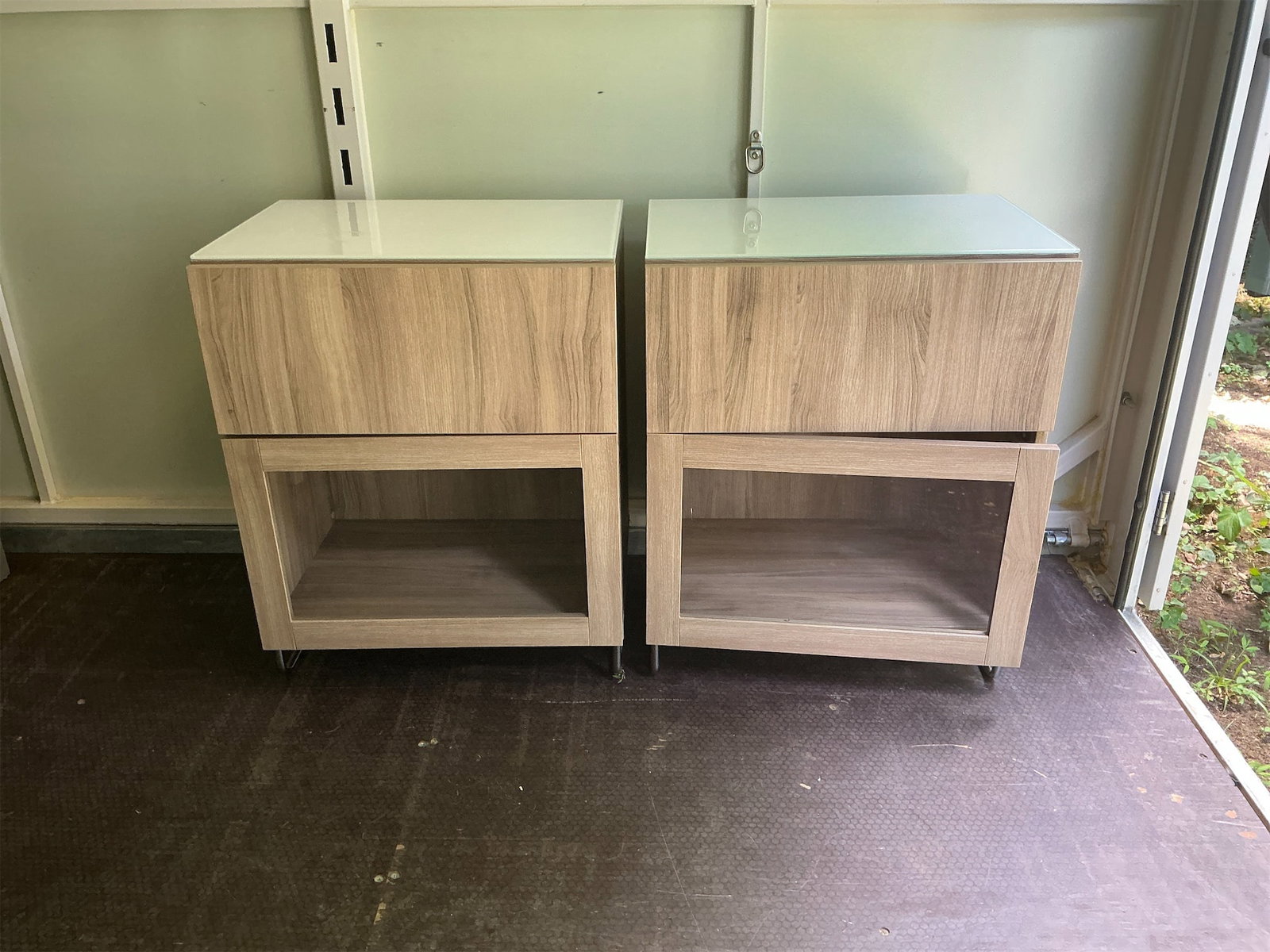 Side Tables: This pair of modern side tables combines functionality with a sleek design. Each table features a wooden frame with a light brown finish, providing a warm and inviting look. The top surface is accentu