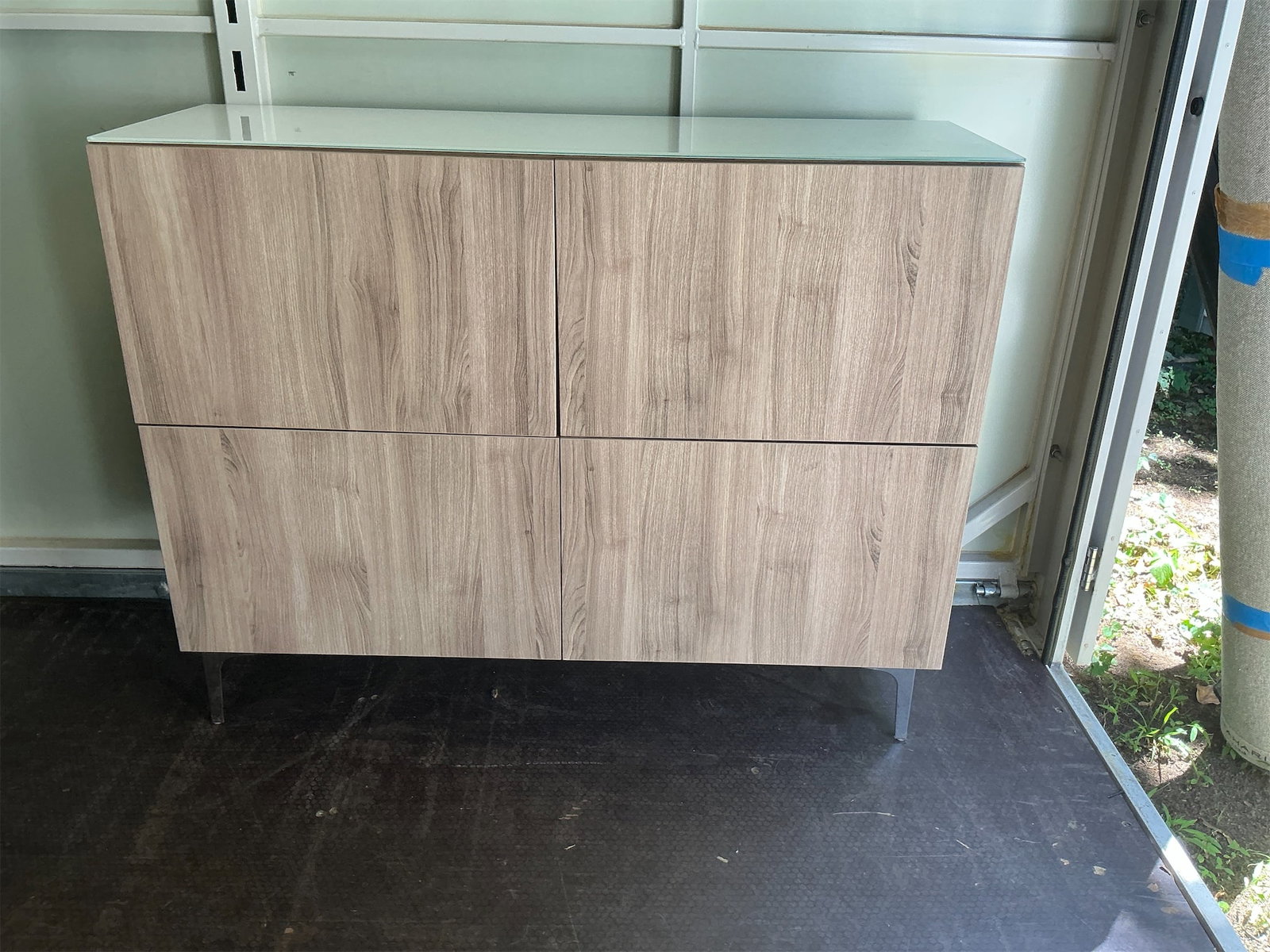 Console Table: Stylish and modern console table featuring a sleek design that blends functionality with contemporary aesthetics. The table is crafted with a wood-like finish, offering a warm and inviting look. It in