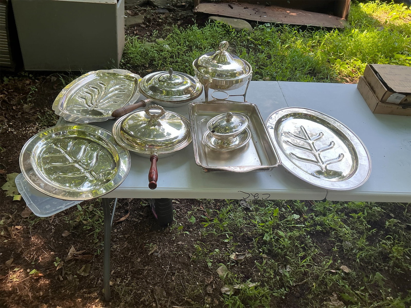 Silver Serving Set: This exquisite Silver Serving Set includes an assortment of elegant pieces ideal for entertaining. The collection features multiple beautifully designed platters, including a large oval tray with a