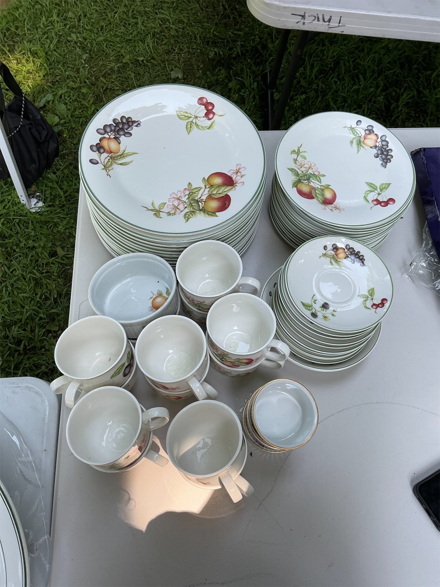 Royal Doulton Ashberry China Set: This Royal Doulton Ashberry China Set features an elegant assortment of tableware adorned with vibrant fruit motifs. The set includes a variety of plates and cups, showcasing detailed floral and
