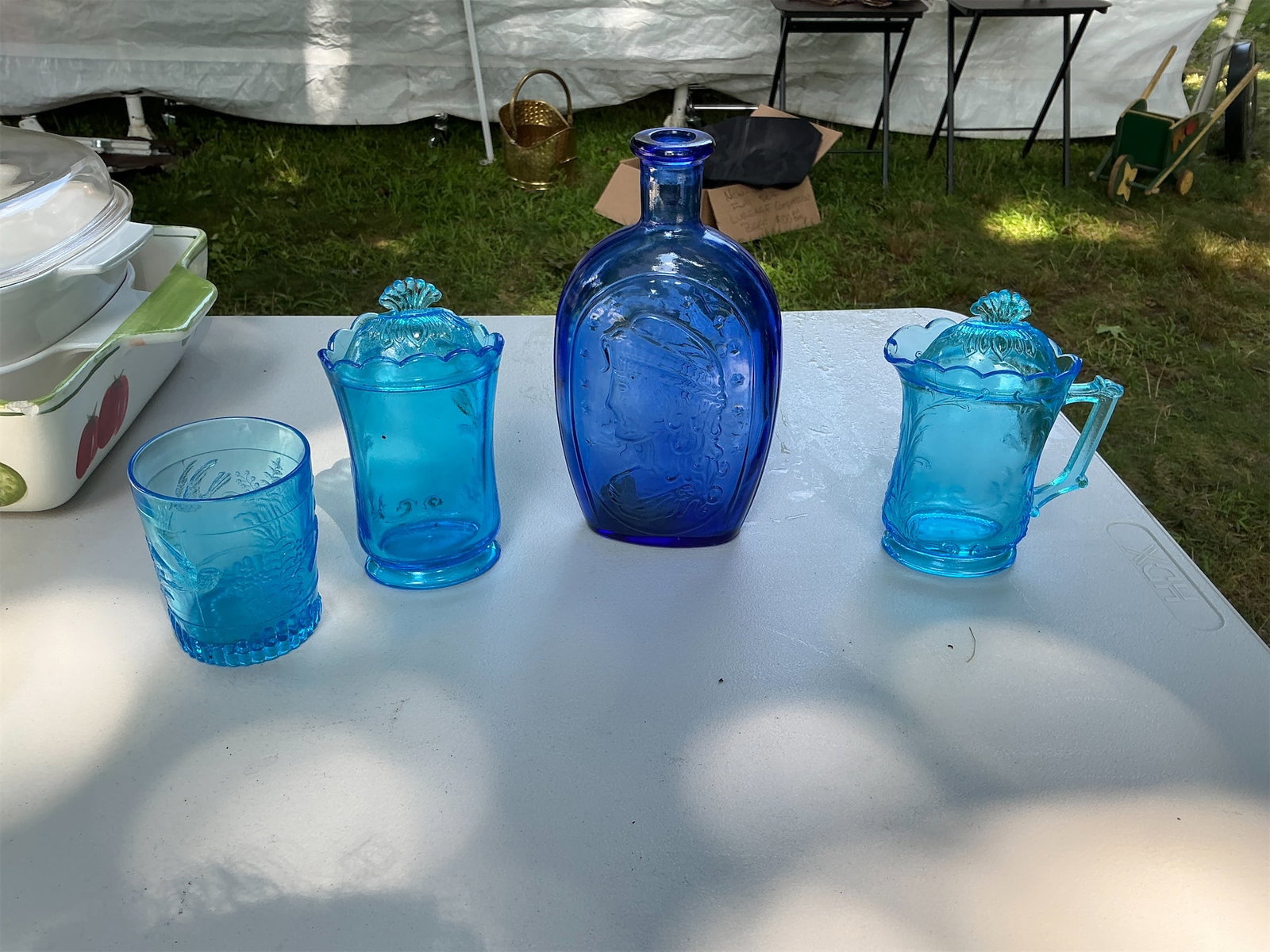 Blue Glassware: This captivating blue glassware set features a delightful assortment of pieces, including two drinking glasses, a creamer, and a charming bottle. Each item showcases a beautiful blue hue, adding a