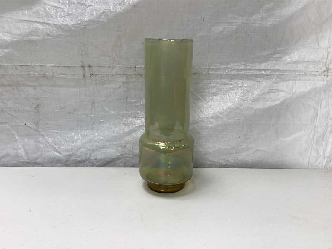 Green Vase from "Terrain": This Green Terrain Vase features a stunning design that blends elegance with a subtle earthy aesthetic. The vase boasts a tall cylindrical shape with a wider base, complemented by a smooth, glossy