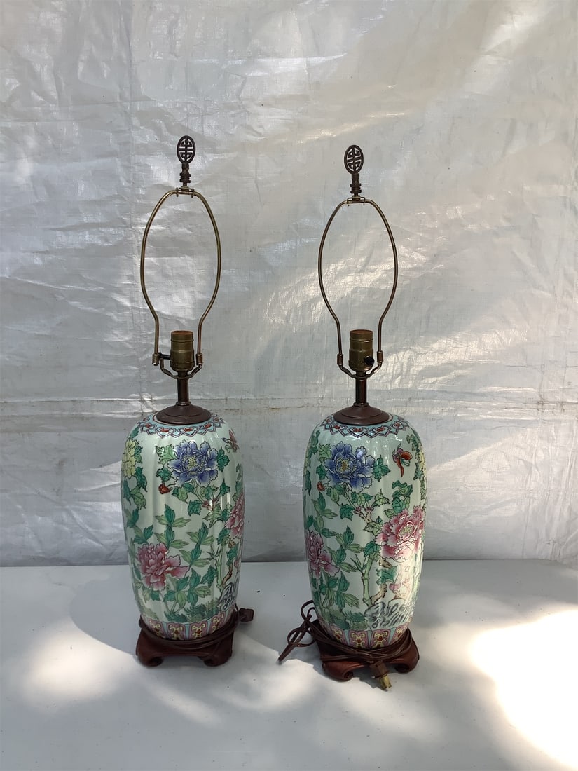Vintage Chinoiserie Lamps: This pair of vintage Chinoiserie lamps features intricate hand-painted floral designs in vibrant colors, showcasing a classic Asian aesthetic. Each lamp is elegantly shaped with a smooth, rounded