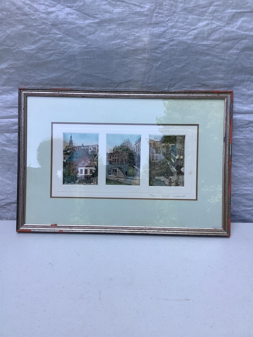 Handcolored Etching of Quebec: This exquisite handcolored etching features three beautiful scenes from Quebec, expertly framed to enhance its charm. Each panel showcases distinctive architectural styles and vibrant colors,