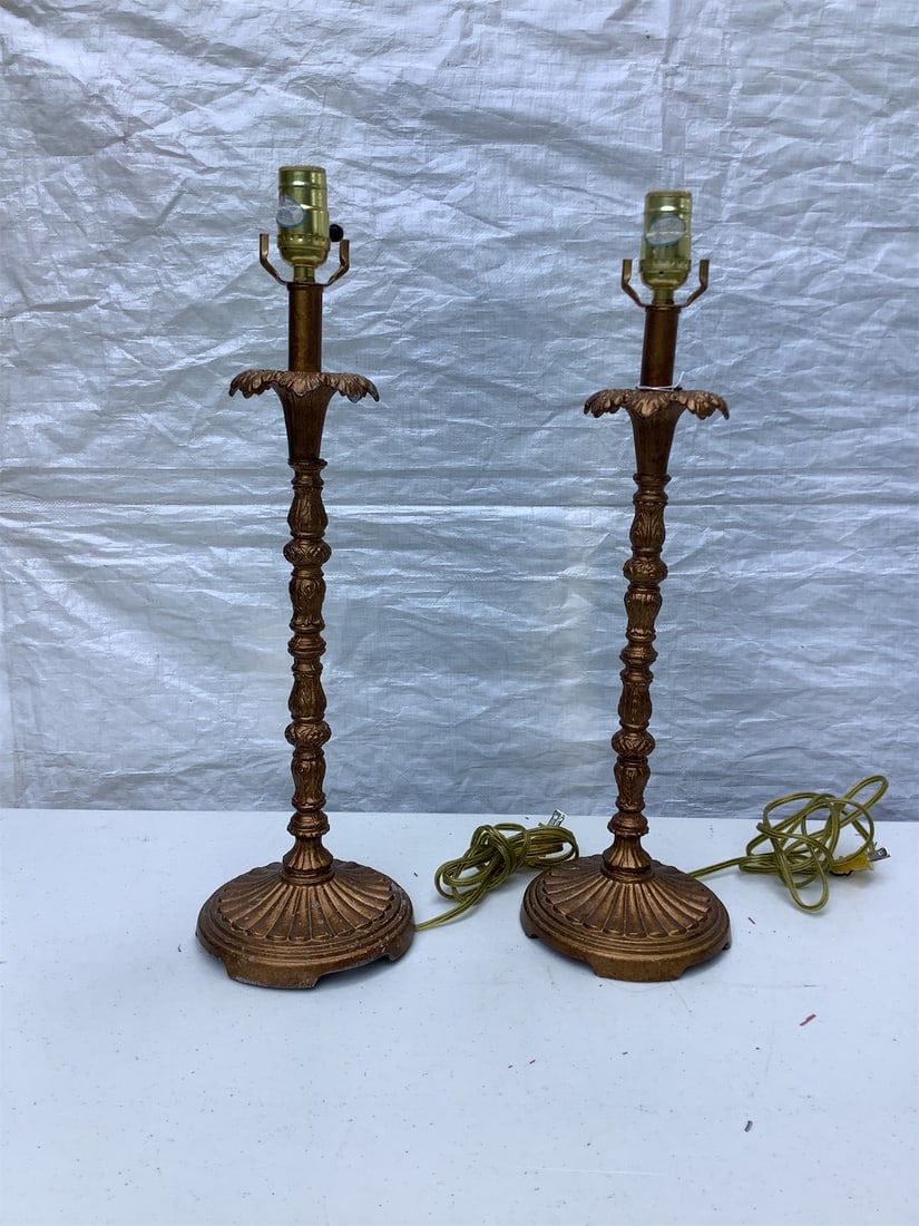 Ornate Copper-Colored Lamps: This listing features a pair of ornate copper-colored lamps that exude vintage charm. Each lamp boasts an elegant design with intricate detailing along the stem and base, while the unique finial adds 