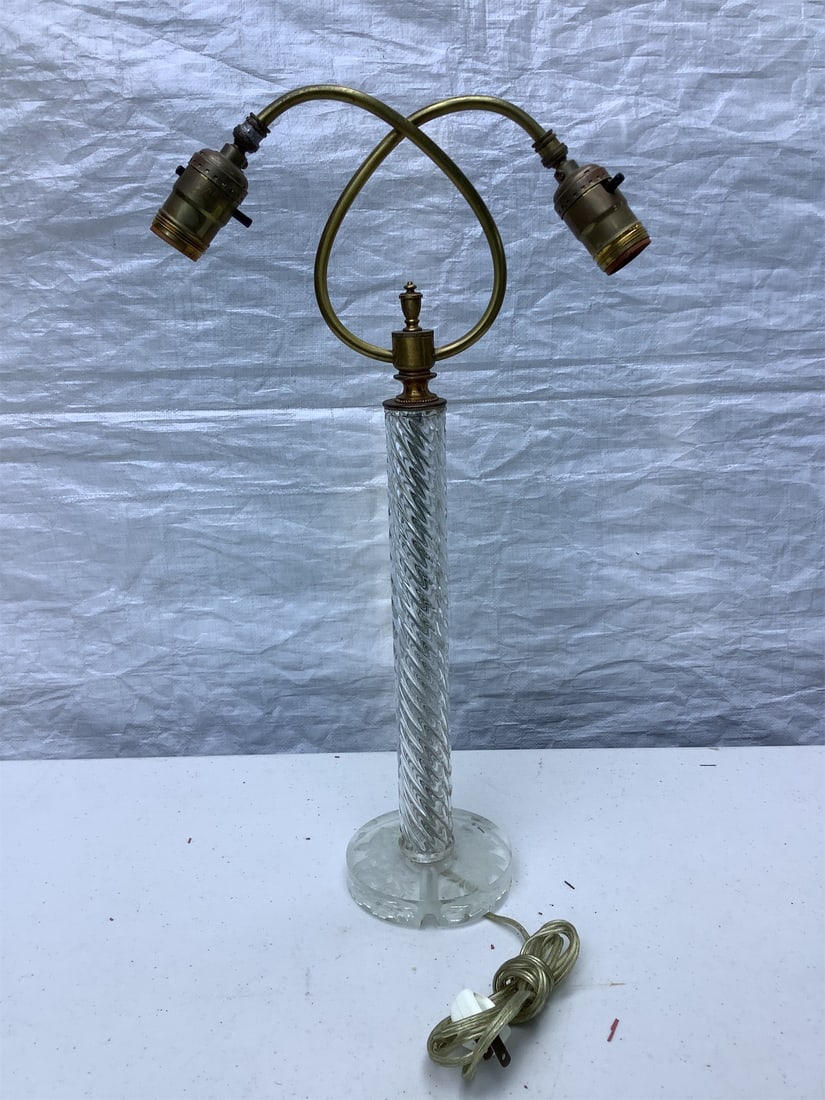 Vintage Glass Lamp: This vintage glass lamp features a striking twisted glass base complemented by a decorative floral design on the base. The lamp is designed with dual sockets that elegantly arch, allowing for