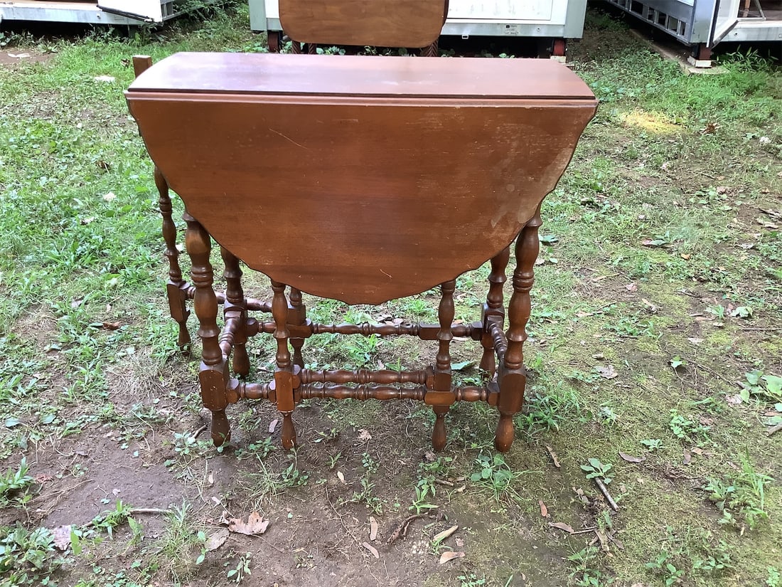 Drop Leaf Table: This charming drop leaf table showcases a classic design, perfect for adding elegance and functionality to any space. The table features a beautiful wooden finish, highlighting the natural grain and