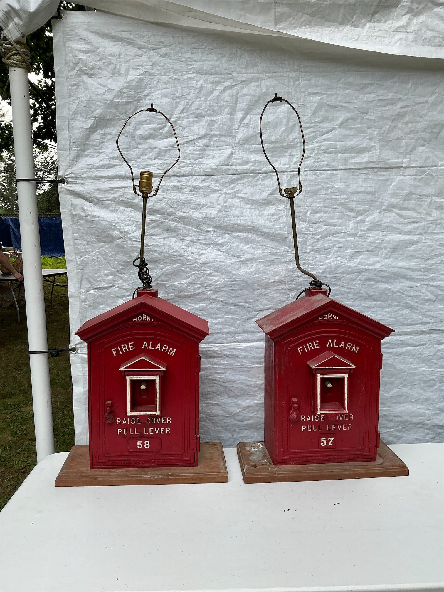 Vintage Horni Fire Alarm Box Lamps: This listing features a unique pair of vintage Horni fire alarm box lamps, creatively transformed from functional fire alarm boxes into eye-catching statement pieces. Each lamp showcases a vibrant