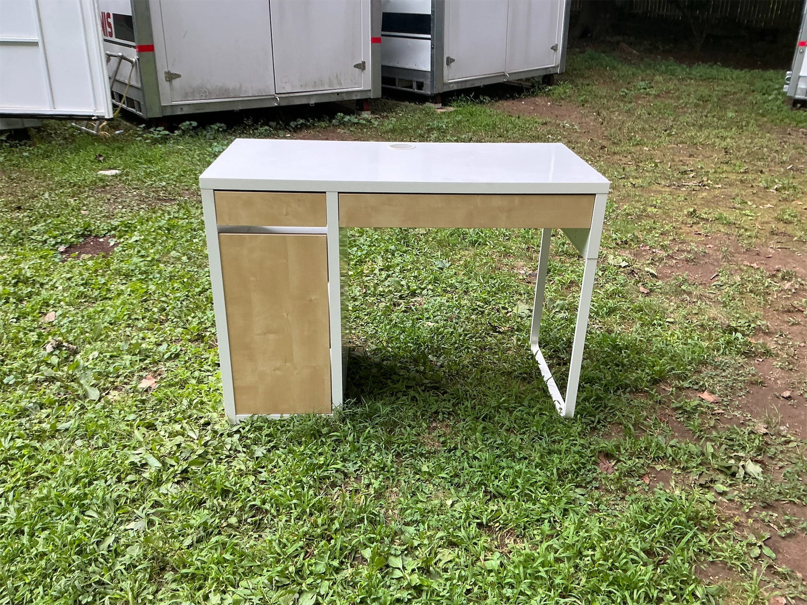 IKEA Desk: This stylish IKEA desk features a sleek design with a combination of a smooth white surface and a light wood finish for the drawer front. It includes two spacious drawers for effective organization
