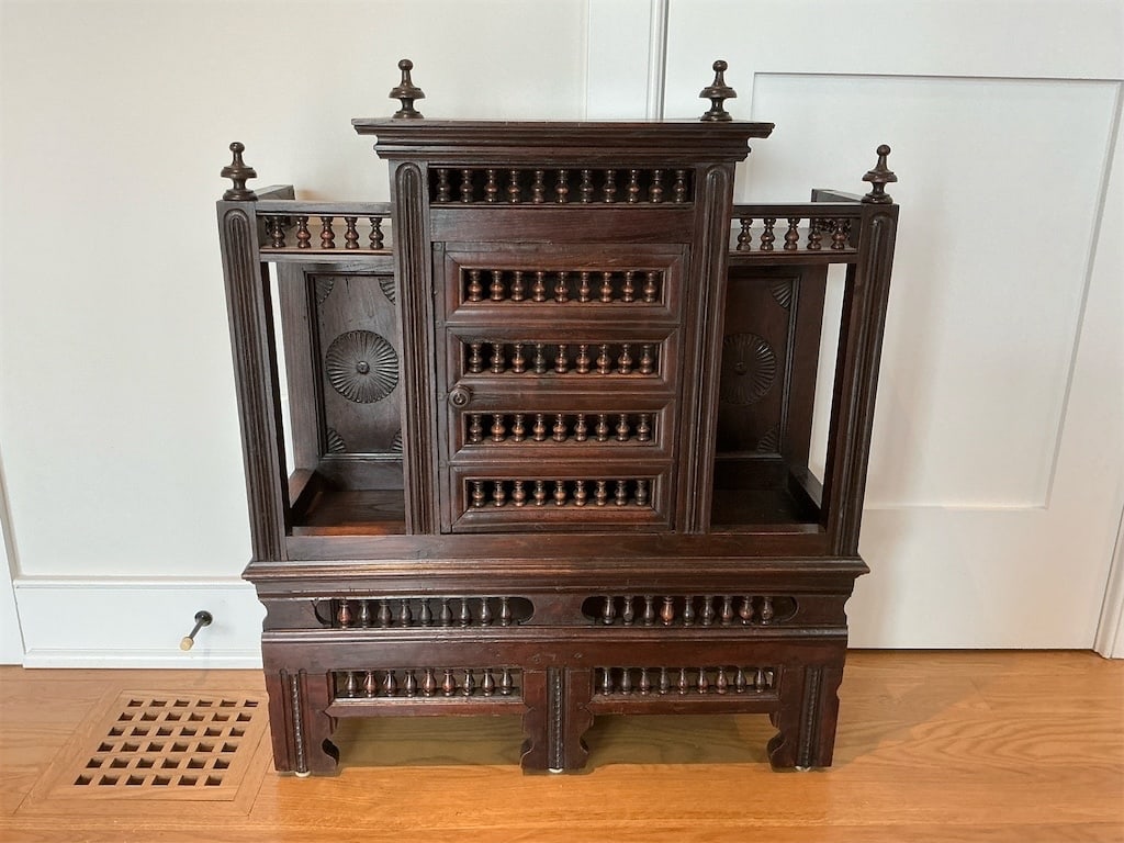 Carved ok French Breton style cabinet: This exquisite carved French Breton style cabinet features intricate detailing and craftsmanship that showcases traditional design elements. The cabinet includes decorative spindle work and tasteful c