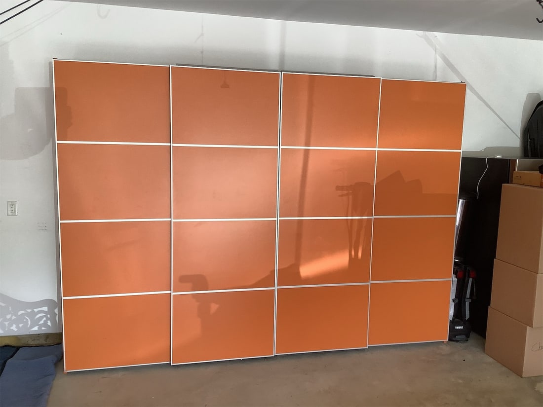 Palazetta Orange Cabinet: This stylish storage system features a modern design with vibrant orange panels and sleek white trim. The unit includes multiple shelves for versatile storage options, as well as a spacious