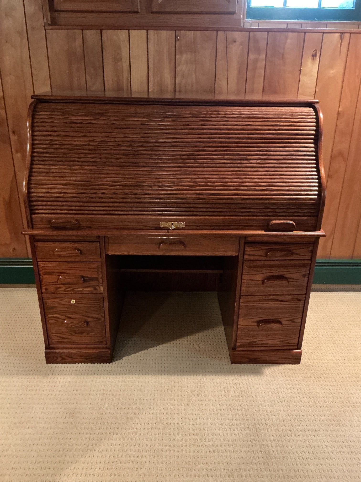 Roll Top Desk: This elegant Roll Top Desk showcases a beautifully crafted design, combining both functionality and classic style. The desk features a unique roll top that elegantly conceals a spacious workspace,