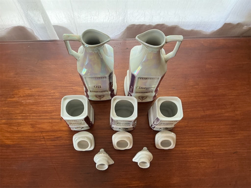 Vintage German Porcelain Pearl Lusterware Oil & Vinegar Cannister Set: This vintage German porcelain cannister set features a beautiful pearl lusterware finish, offering a stunning addition to any kitchen or dining area. The set includes two elegantly designed jugs