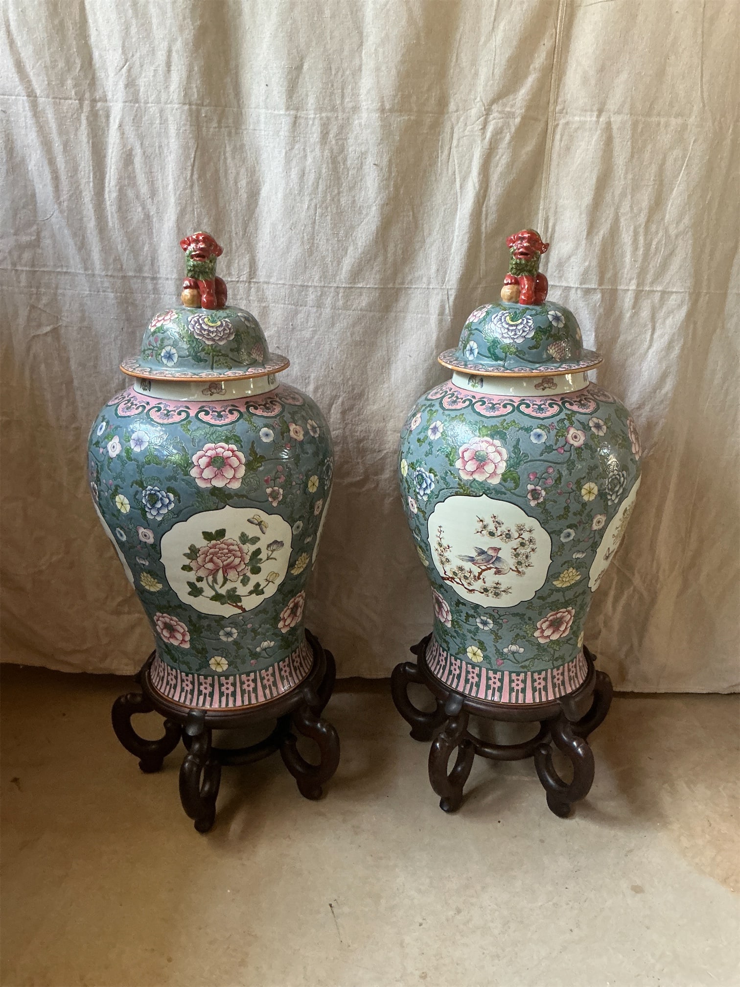 Pair of Chinese Repro Temple Jars with Stands: This elegant pair of Chinese Repno Temple Jars features intricate designs and vibrant colors that reflect traditional craftsmanship. Each jar is adorned with floral motifs and decorative panels,