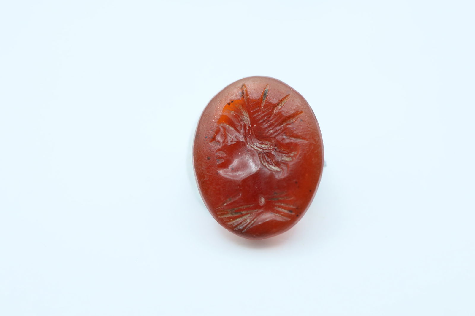 Roman Carnelian Intaglio with Sol Invictus 1st-3rd Century AD: A oval carnelian intaglio with engraved image of Sol Invictus; 0.6 grams, 12.5mm diameter. From the inventory of EU auction house.