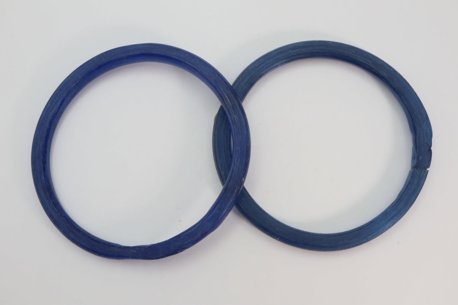 Migration Period Blue Glass Bracelets, Circa 5th, 6th Century AD: A pair of blue glass bracelets; 28.57 grams, diameter 68mm -69mm.Property of EU collector. Fine condition.